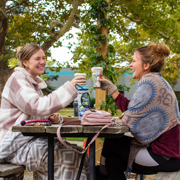 customers wrapped in blankets and hanging out on the rosewood lawn with drinks