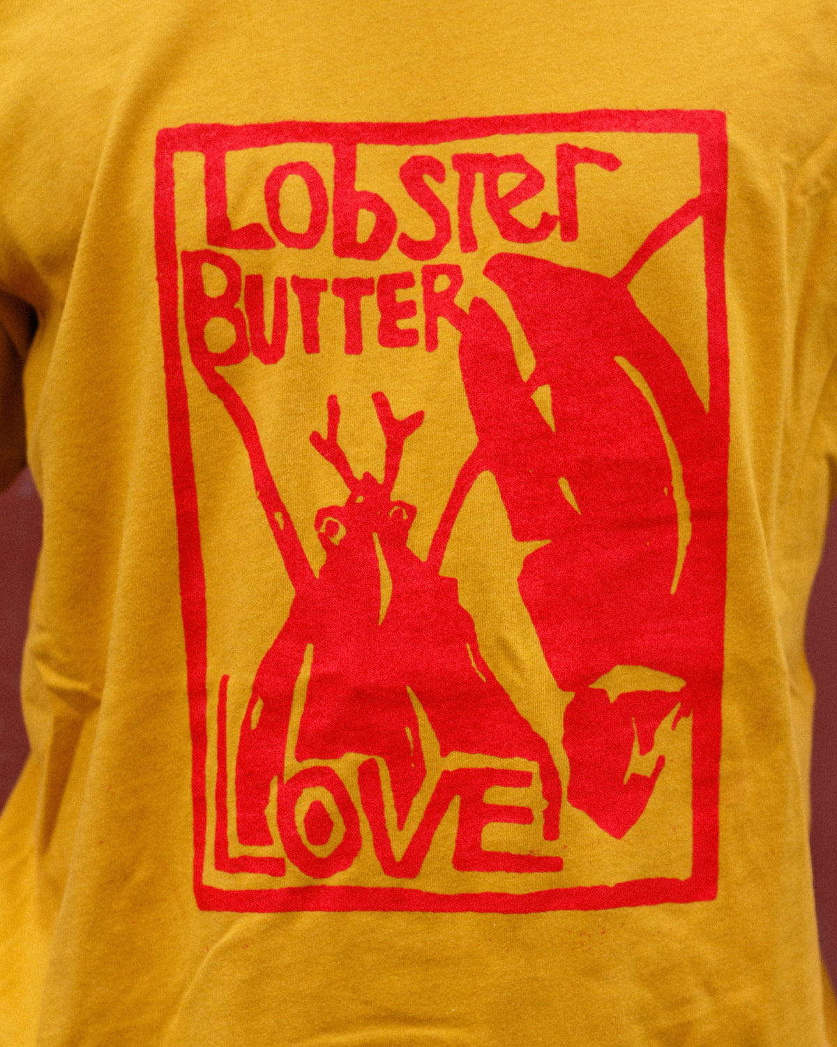 Yellow t-shirt with red 'Lobster Butter Love' graphic design.