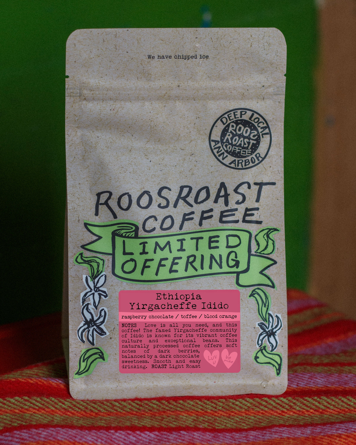 Roosroast Coffee package on a colorful fabric background