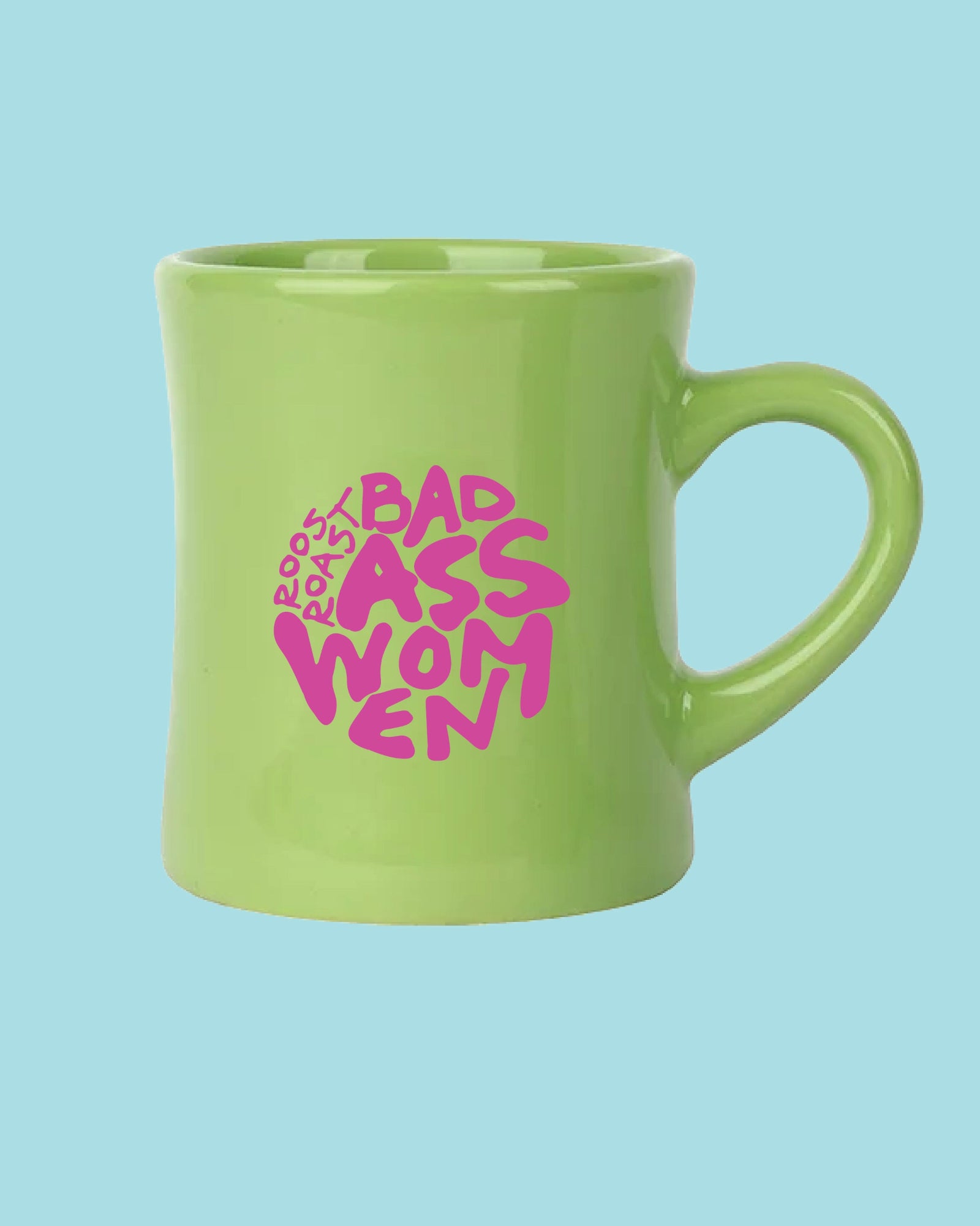 A bright lime green ceramic mug with a pink graphic that reads 'ROOT BAD ASS WOMEN' in a stylized hand-drawn font, set against a solid light blue background.