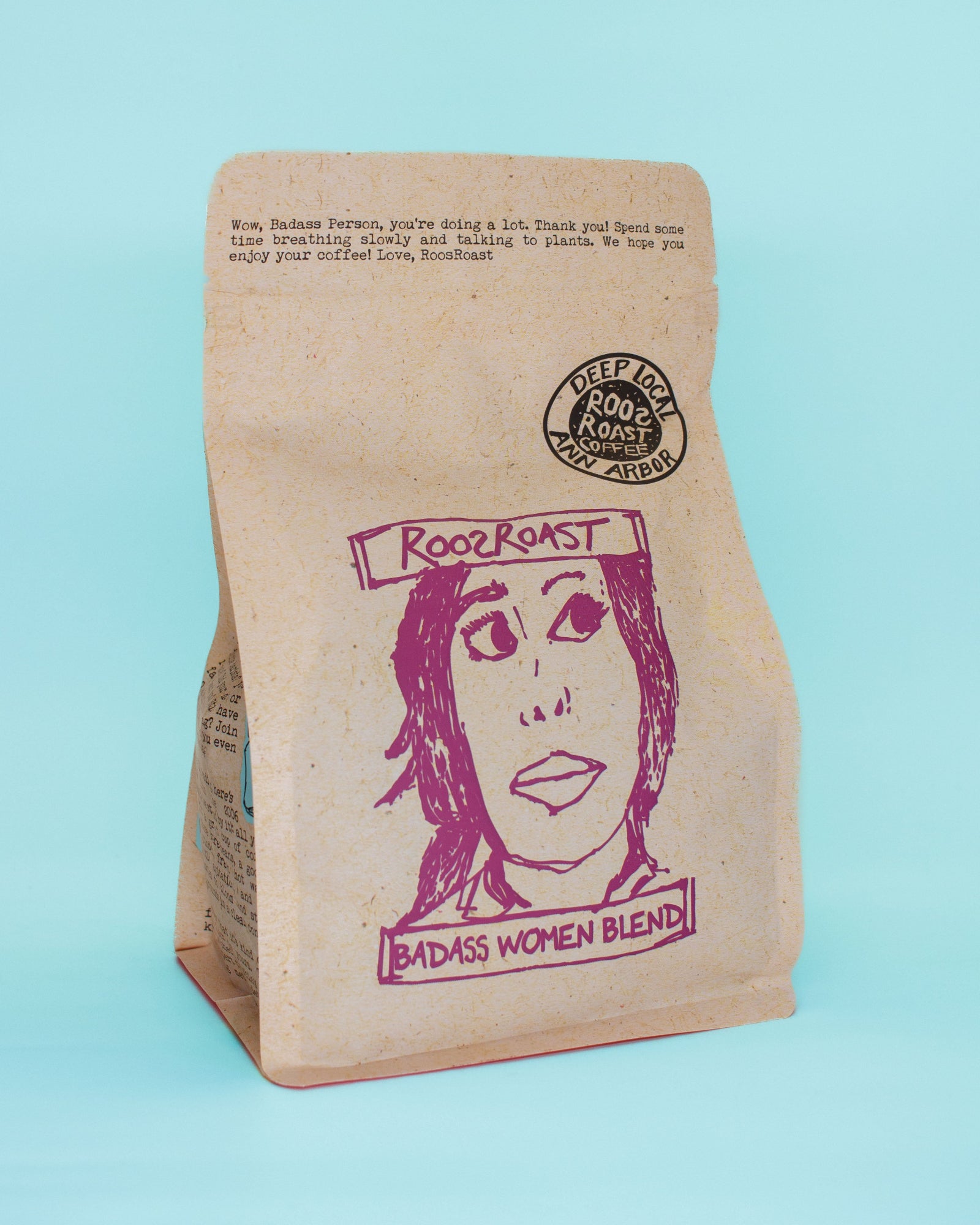 Coffee bag labeled 'RoosRoast Badass Women Blend' on a light blue background