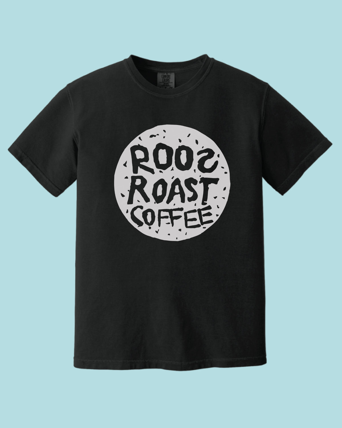 A black short-sleeve crewneck t-shirt featuring a circular graphic on the chest with the text 'ROO2 ROAST COFFEE' in a distressed white circle, set against a solid light blue background.