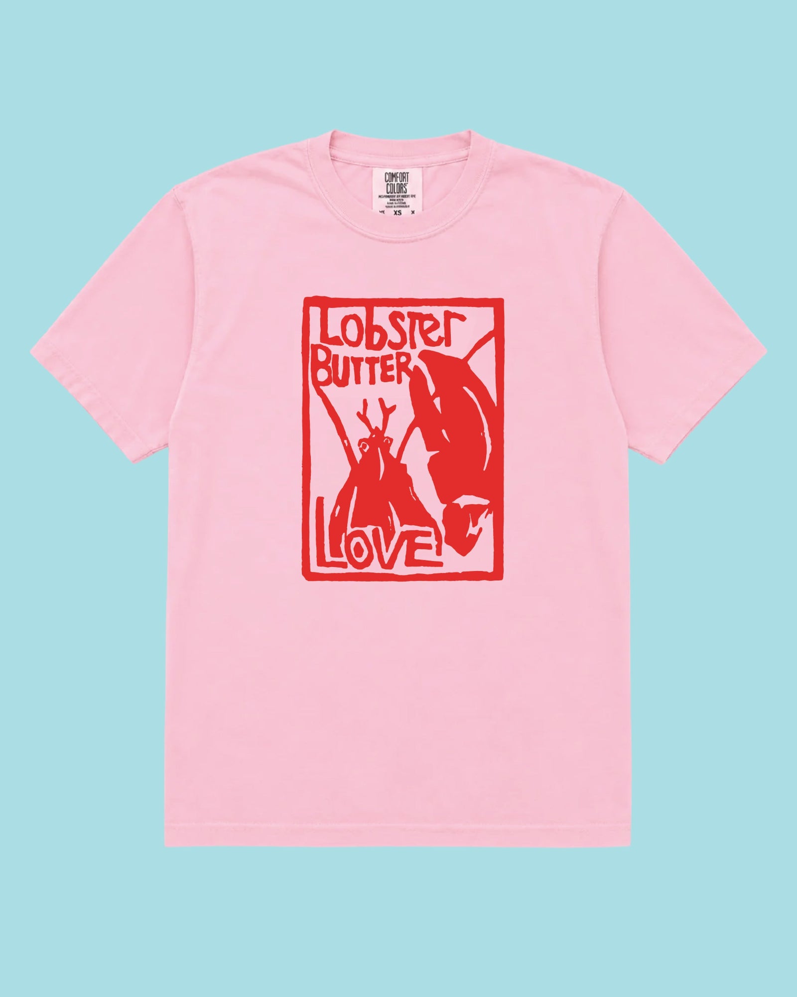 A light pink short-sleeve crewneck t-shirt with a red graphic print on the front featuring a lobster, butter, and the words 'LOBBER BUTTER LOVE'. The shirt is displayed flat against a solid light blue background.