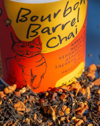 Bourbon Barrel Chai tea can with tea leaves in the foreground