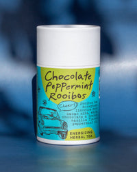 Tea canister with a colorful label on a blue background