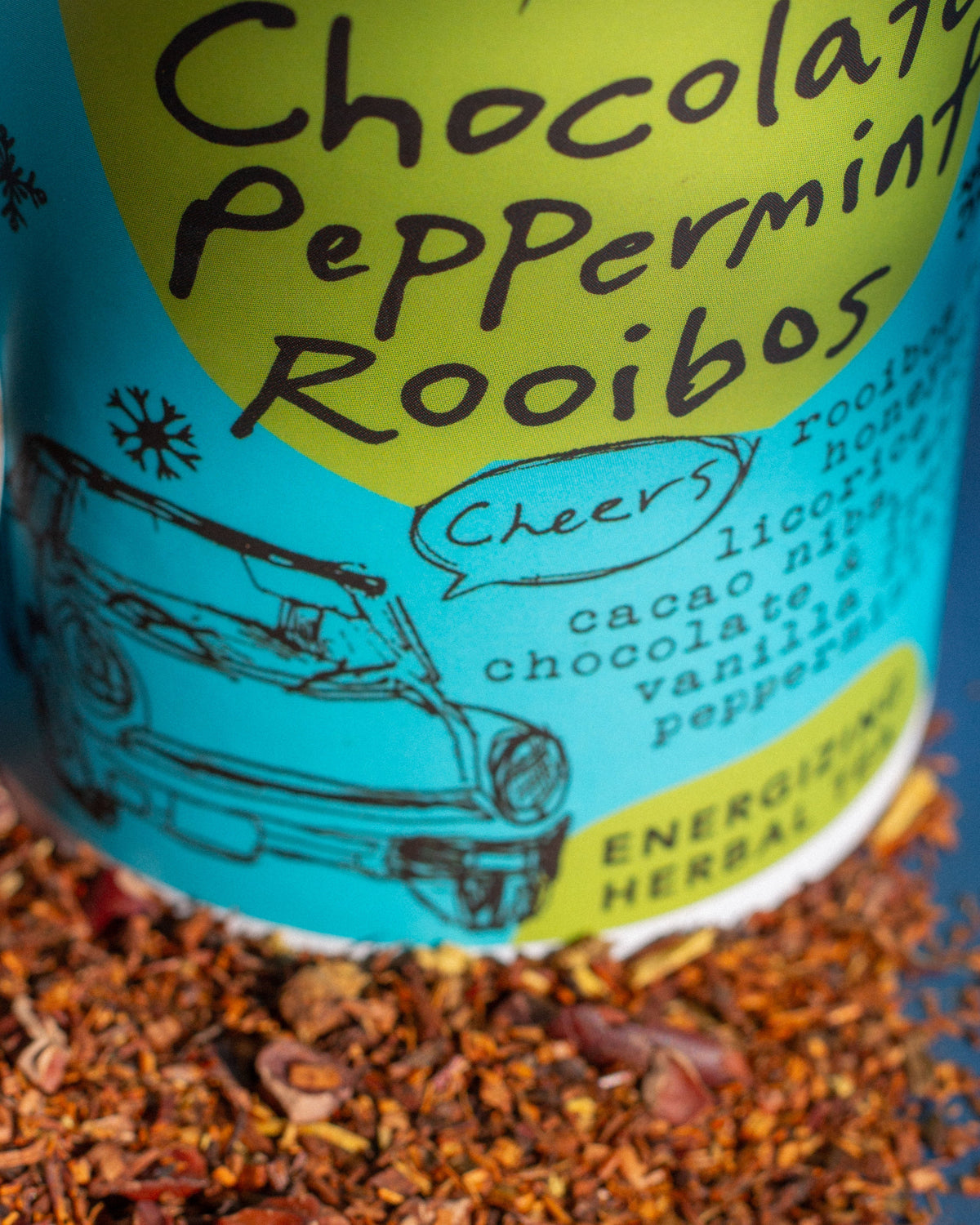 Tea packaging with 'Chocolate Peppermint Rooibos' text and illustrations on a blue and yellow background.