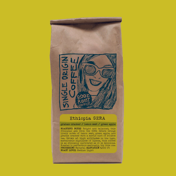 Brown coffee bag with a graphic of a woman and text on a bright yellow background