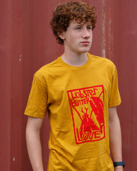 Person wearing a yellow t-shirt with a red graphic design against a red background