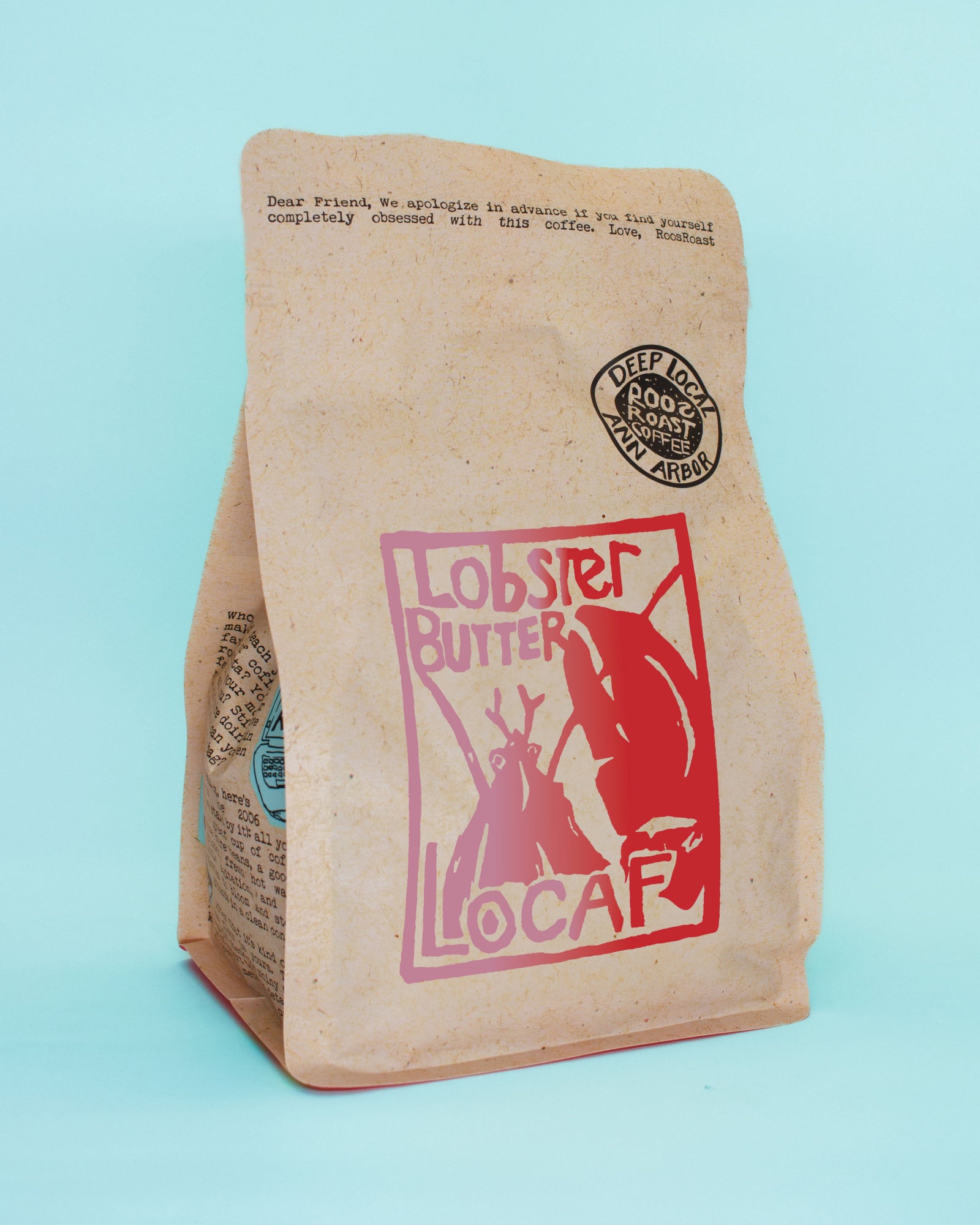 Kraft paper coffee bag with lobster butter logo on a light blue background