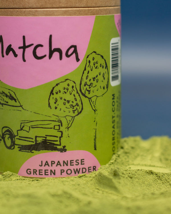 Matcha green powder with a green and pink label on a blue background