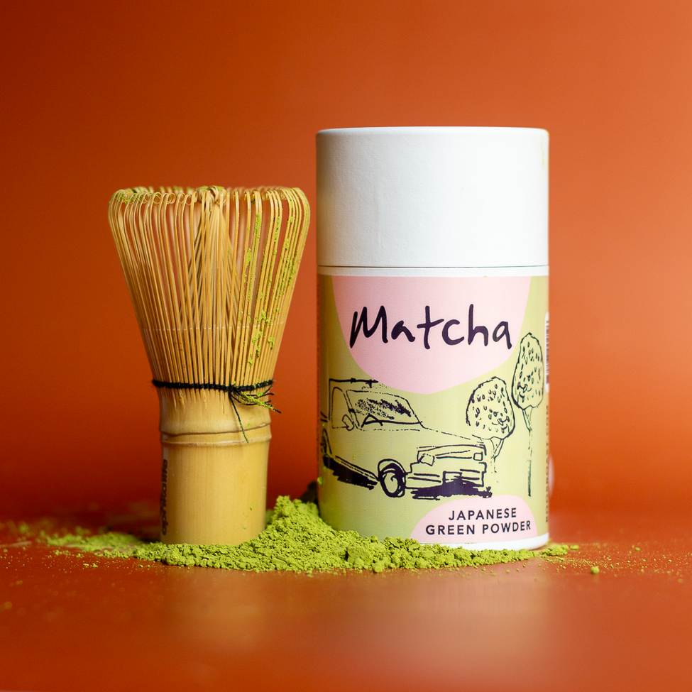 matcha green tea in pulp paper tube and a whisk