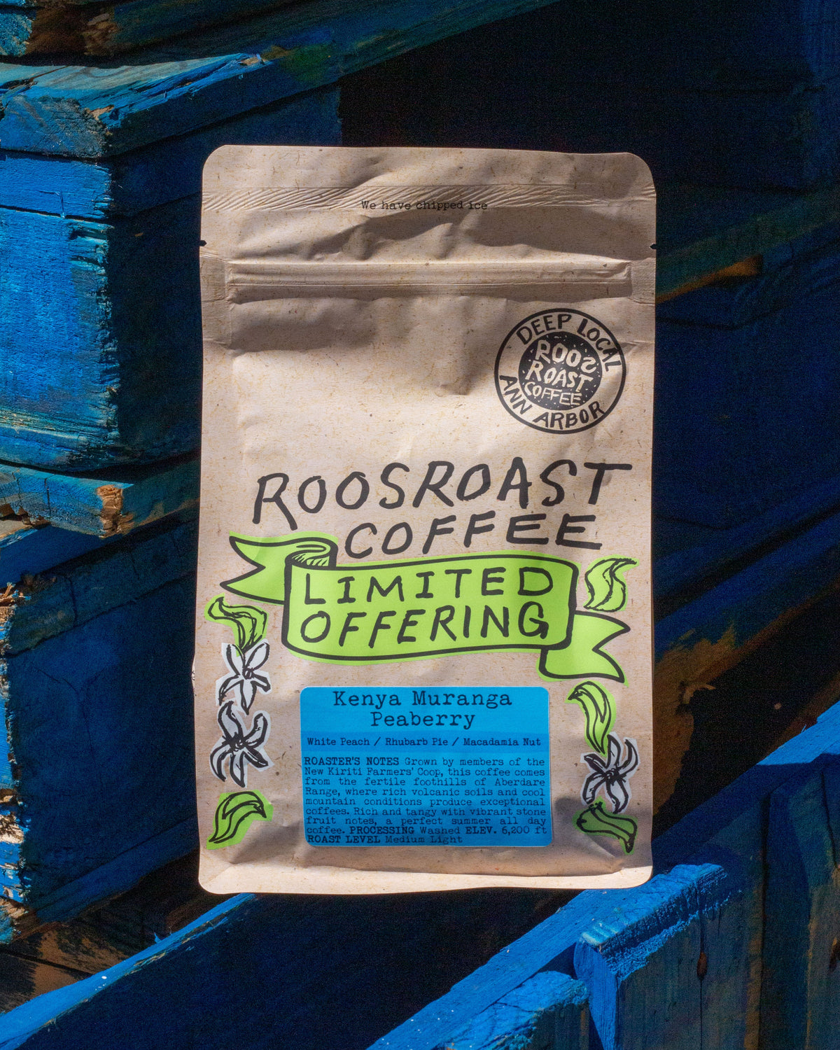 Roosroast Coffee package on a blue wooden background
