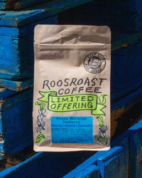 Roosroast Coffee package on a blue wooden background