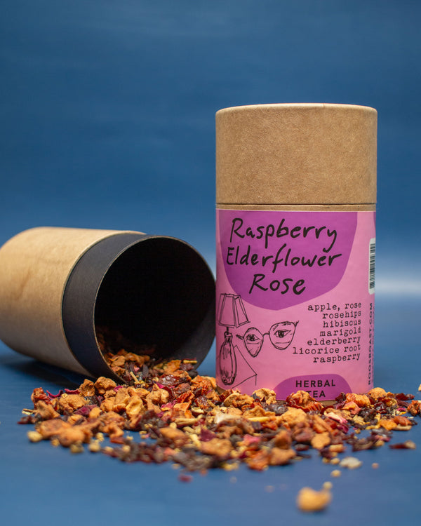 Herbal tea packaging with loose tea leaves on a blue background