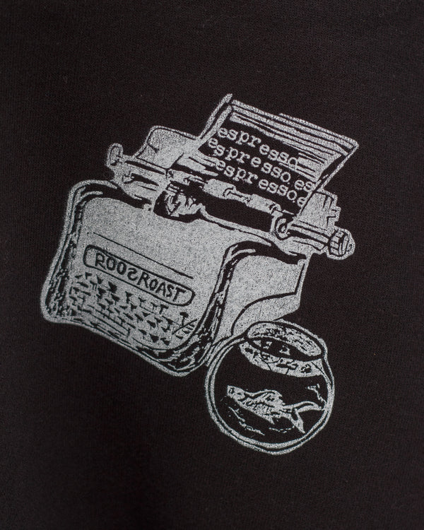 Black t-shirt with white graphic design of a coffee grinder and espresso beans on a black background