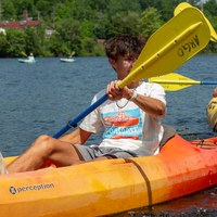 kid kayaking at argo pond in screen printed fishing boat t-shirt 